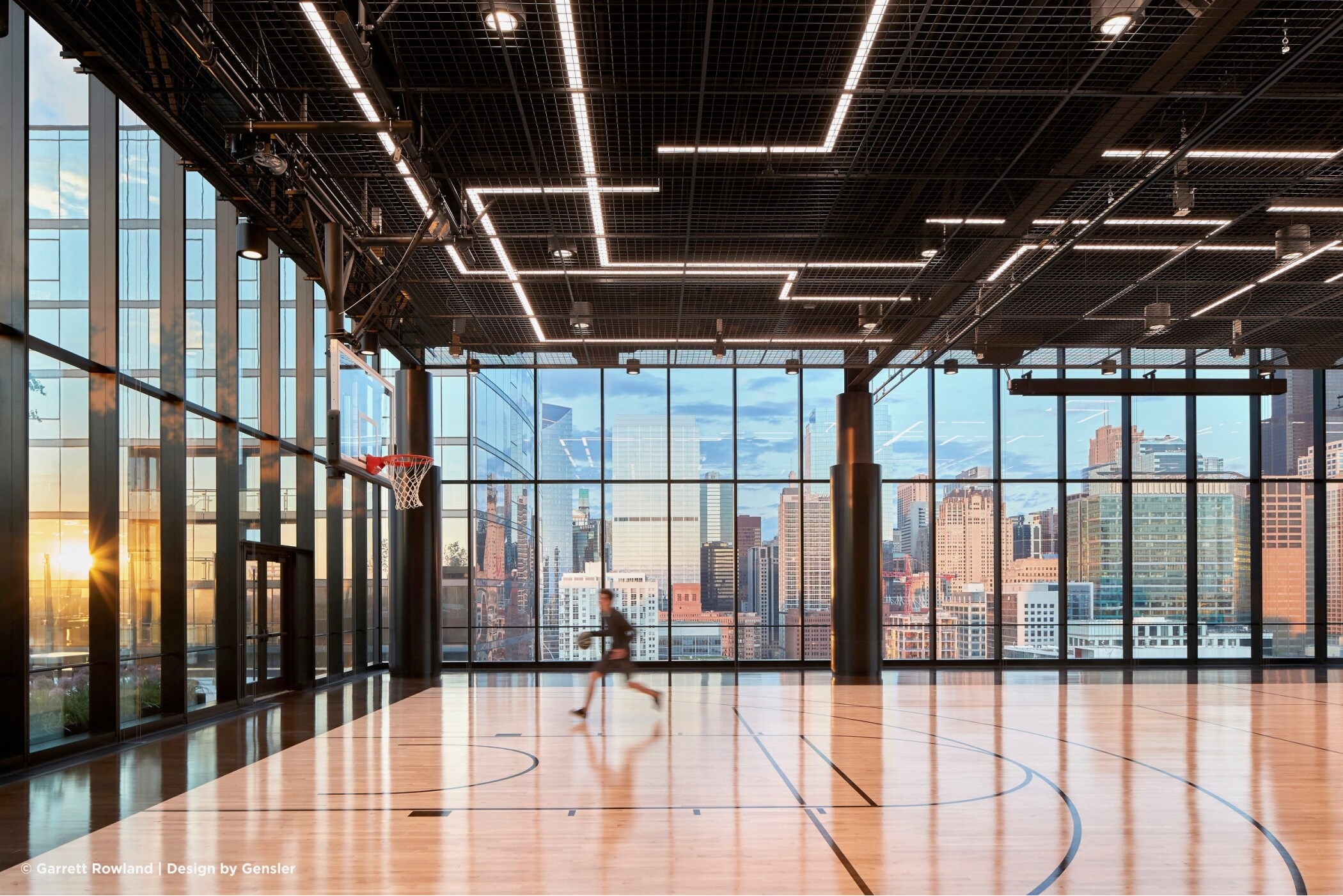 A basketball court that has provided NBA stars, A-list celebrities and even U.S. presidents with sweeping views of Chicago's skyline from its location in the top of a 17-story office building was one of CoStar's top-read office stories of 2024. (Garrett Rowland/Gensler)