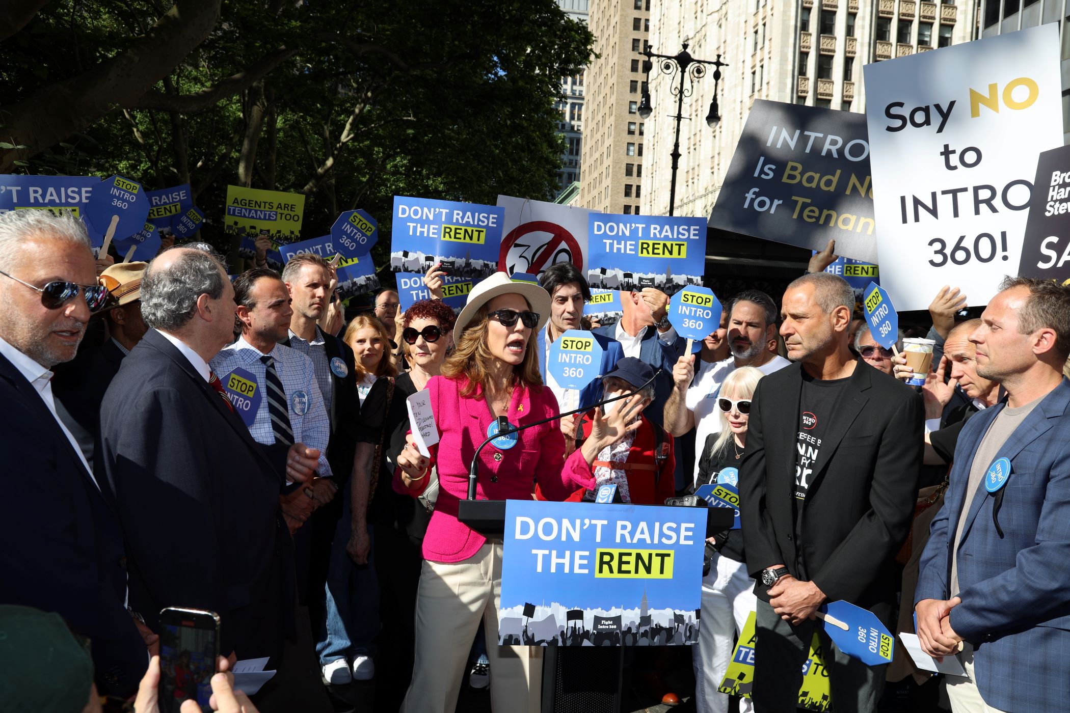 About 1,500 New York real estate professionals, including Bess Freedman, CEO of brokerage Brown Harris Stevens, center, gathered outside City Hall to protest against a proposed bill to ban broker fees. (Real Estate Board of New York)