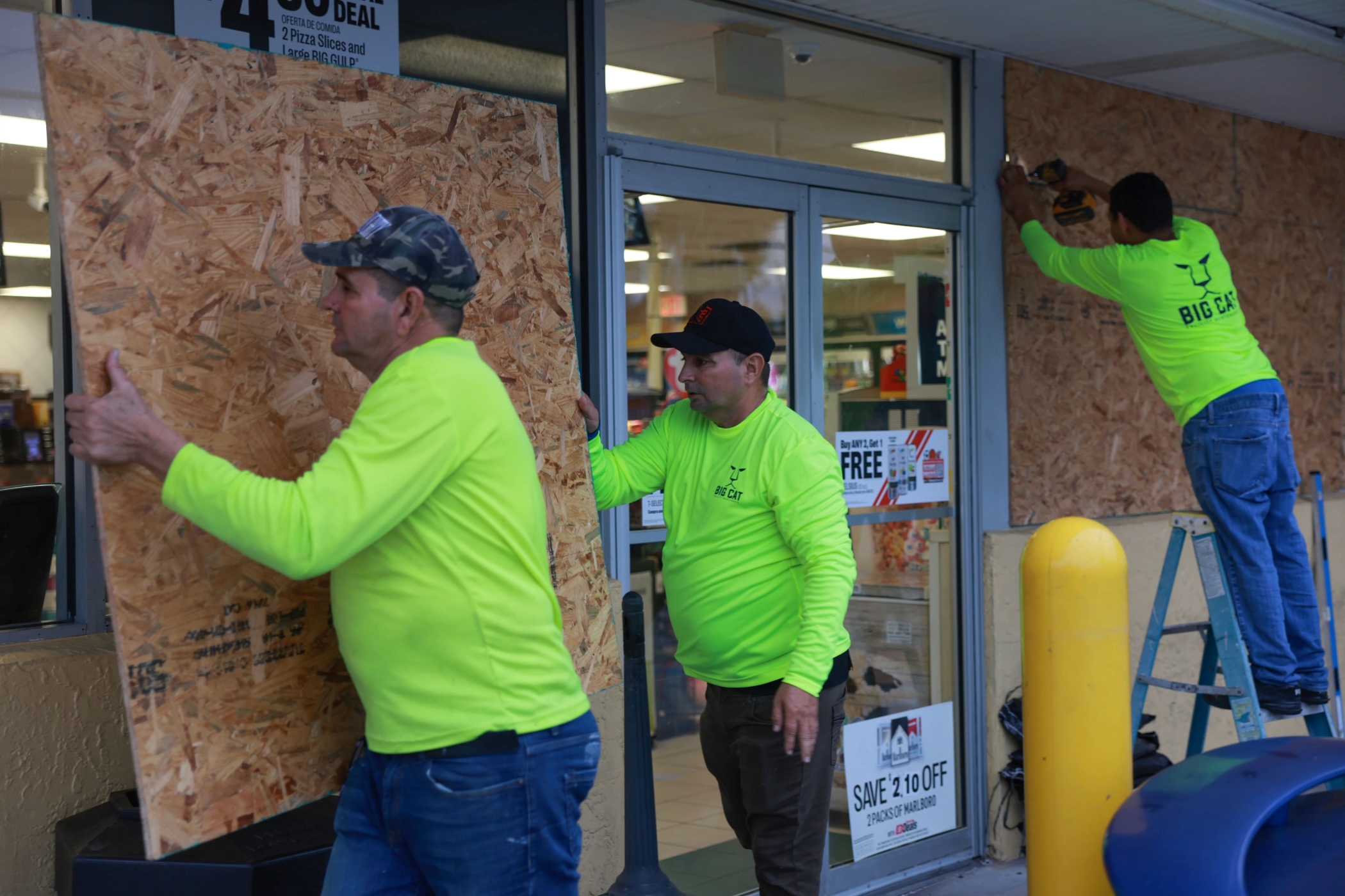 Workers place plywood over the windows of a business in Clearwater, Florida, ahead of the arrival of Hurricane Helene, the eighth named storm of the season. (Joe Raedle/Getty Images)
