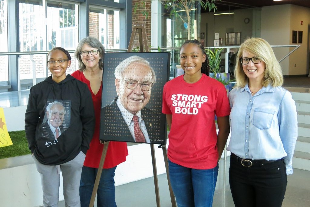 A high-tech portrait of billionaire investor Warren Buffett sold for more than $75,000 at an auction. From left, Janaii Blair, Girls Inc. member; Roberta Wilhelm, executive director of Girls Inc. of Omaha; Jordan Blair, Girls Inc. member; and Sharon Livneh, a Motiva senior vice president. (Motiva)