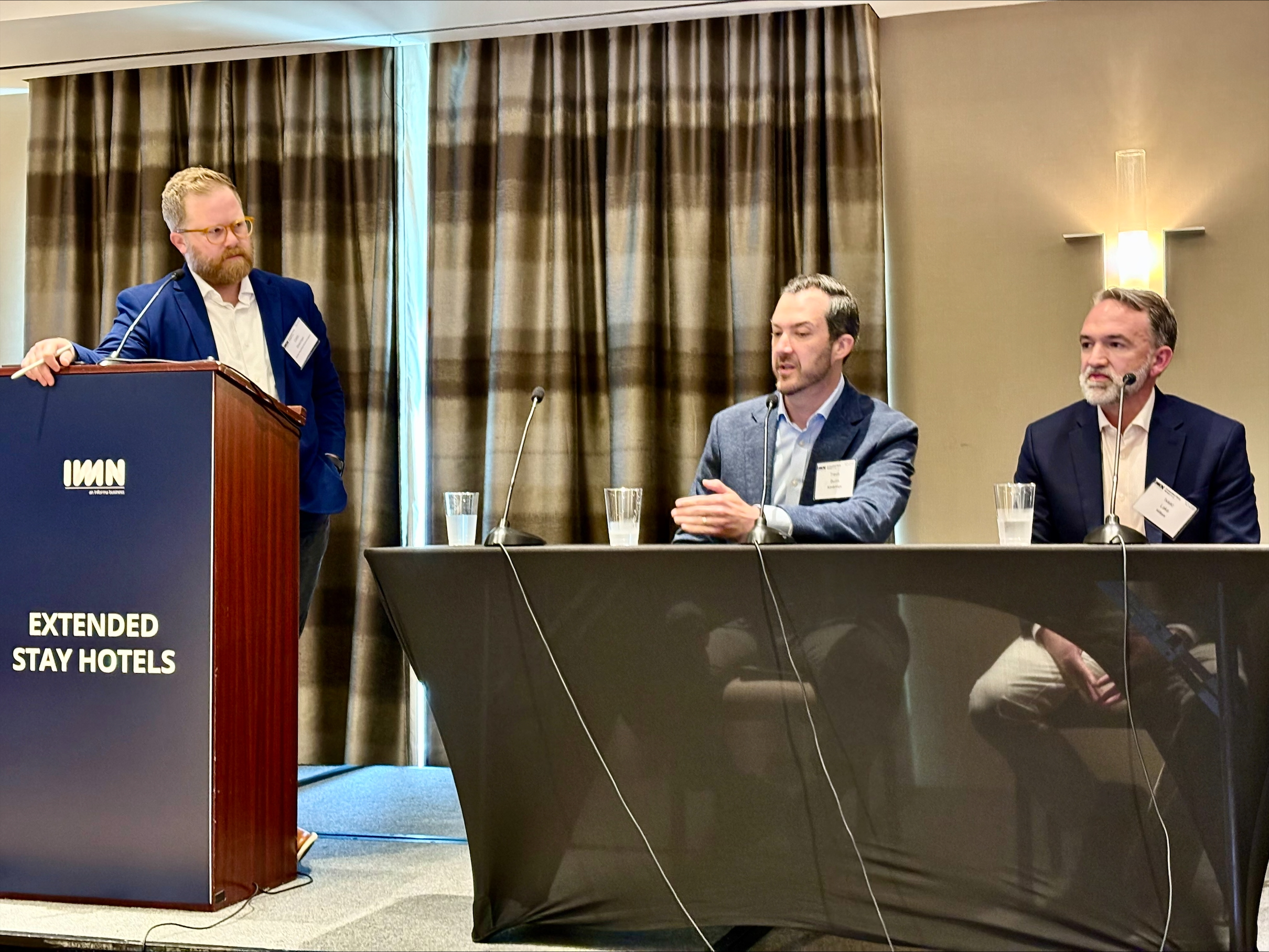 CoStar Director of Hospitality Analytics Colin Sherman (standing left) moderates the executive panel discussion at the IMN Extended Stay Forum in Atlanta, 