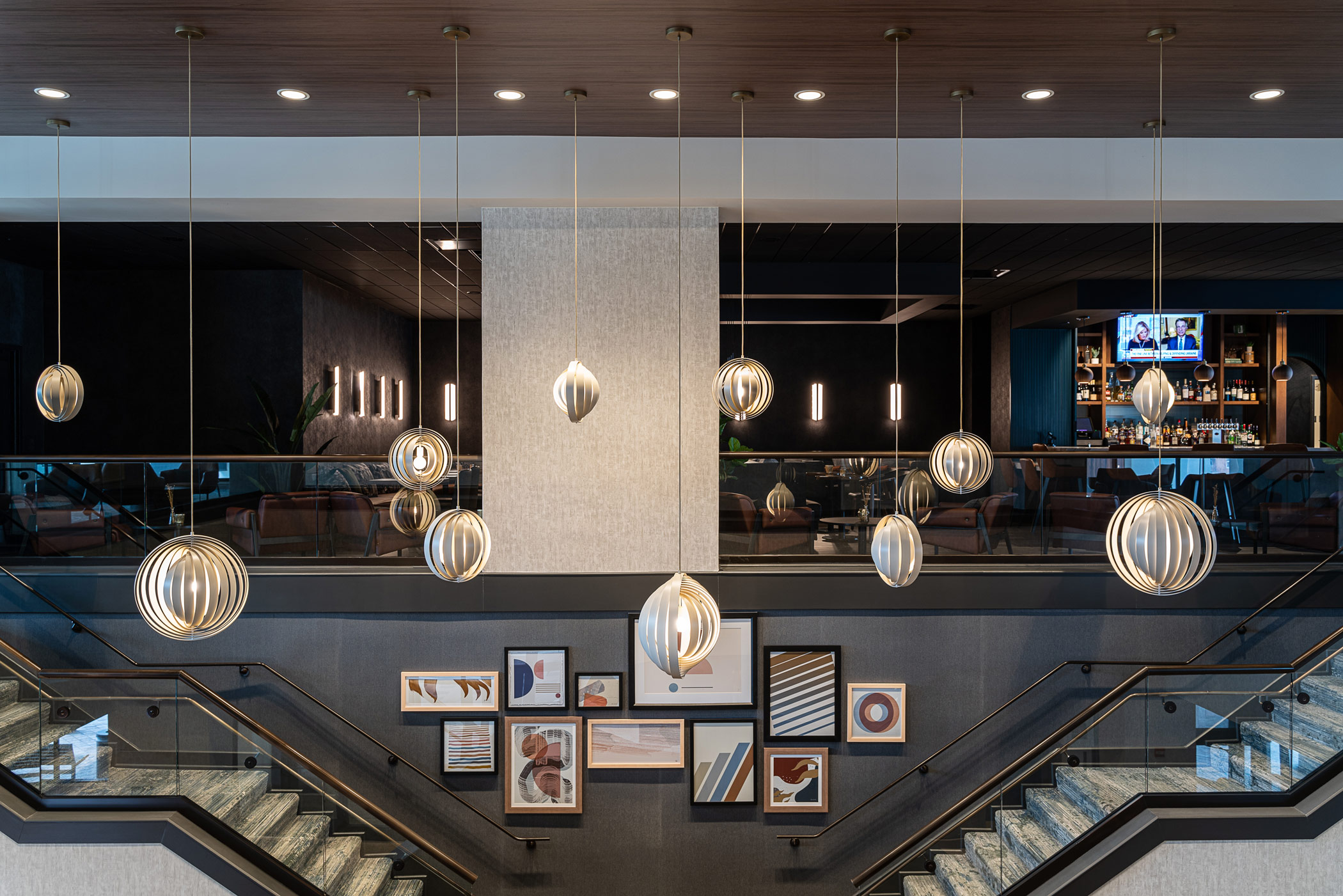Designers often showcase lighting installations to complement architectural elements in a hotel like a grand staircase. Shown is the Sheraton Reston Hotel in Reston, Virginia. (Joseph Tran)