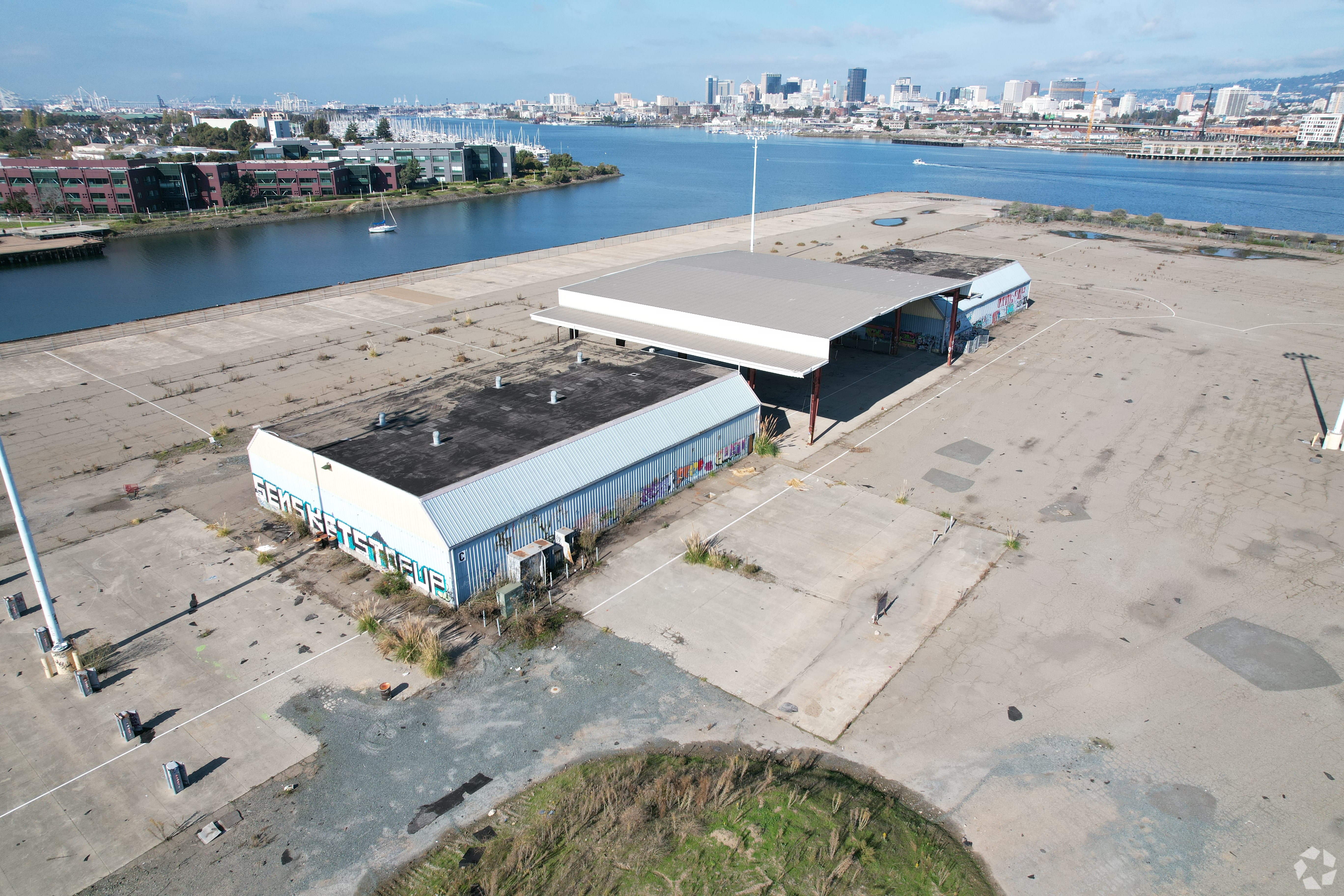 The 100-year-old Encinal Terminal site, built in 1925 and used as a supply depot during World War II, has stood vacant on the Alameda waterfront since it closed down in the 1990s. (CoStar)