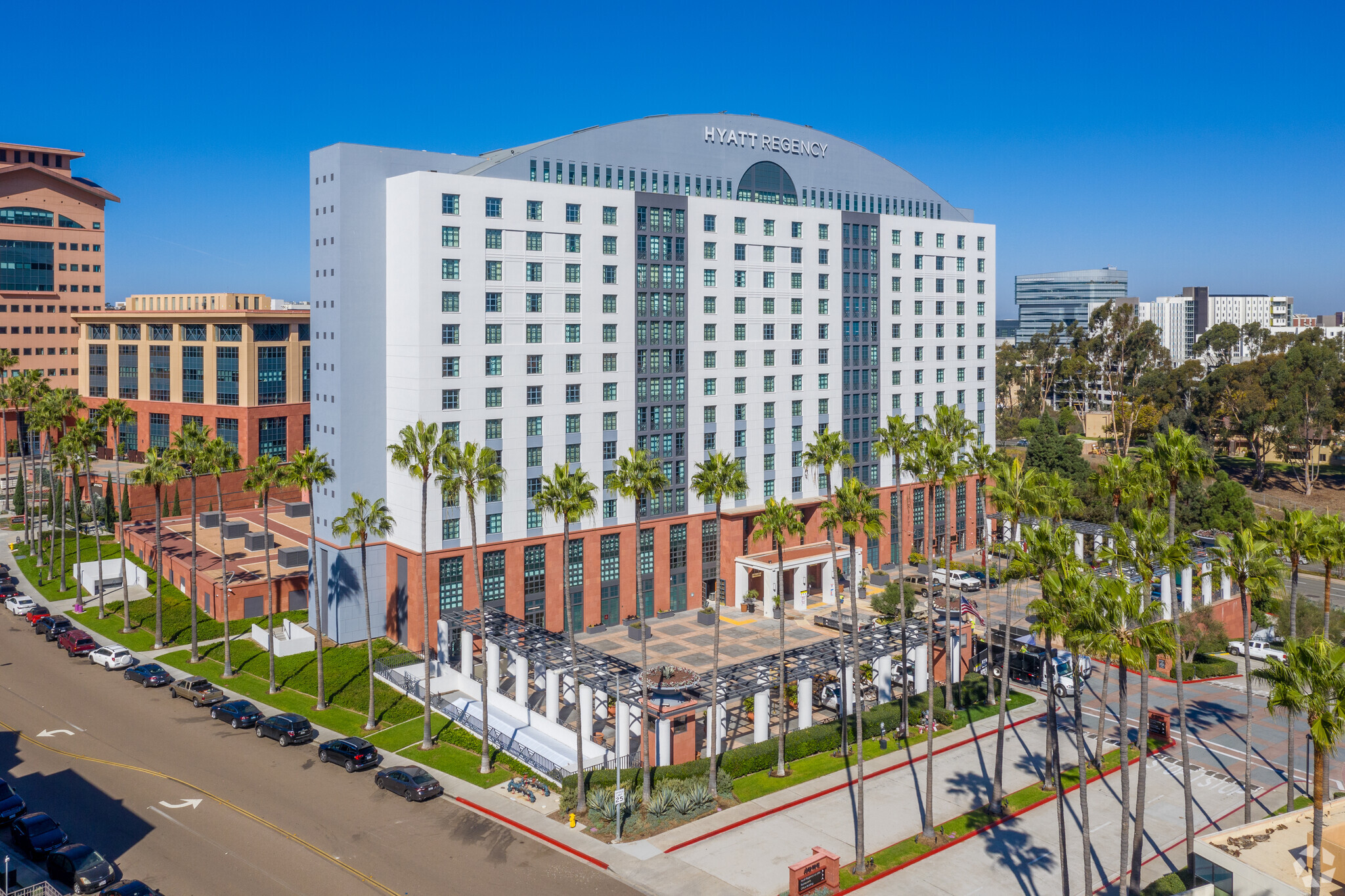 IQHQ acquired the Hyatt Regency in San Diego's UTC neighborhood for more than $216 million. The hotel is next door to an office building, at left, purchased in October 2021 by the biotech-focused REIT. (CoStar)