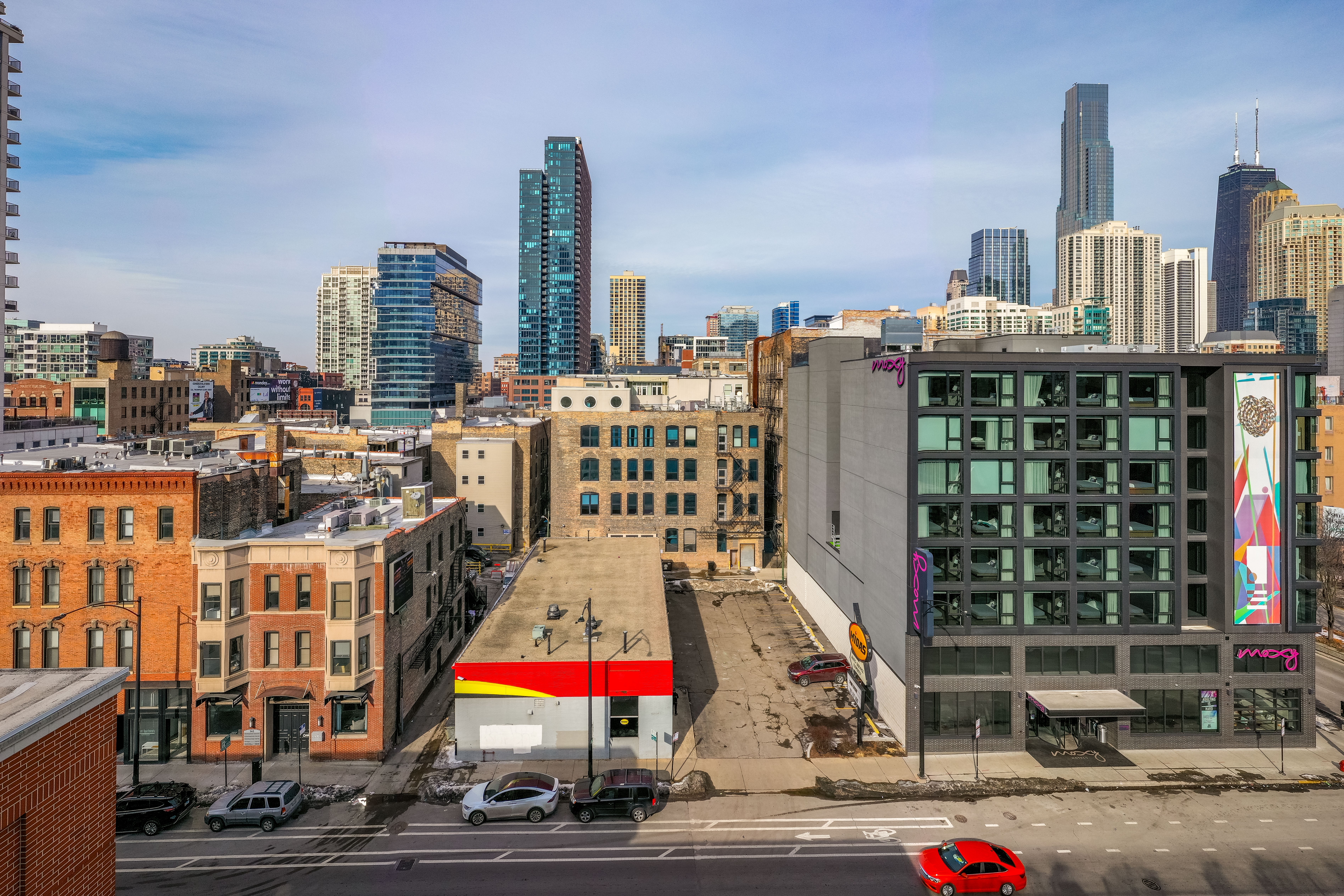 Friedman Properties has bought the site of a former Midas auto shop in Chicago’s River North, next to a Moxy hotel the developer built in 2018. (NAI Miami)