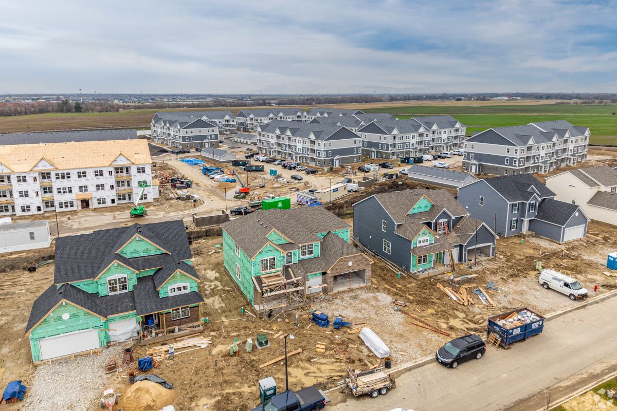 Emblem Oswego, in background, near Chicago is one of three recent multifamily openings for developer Quarterra. (CoStar)