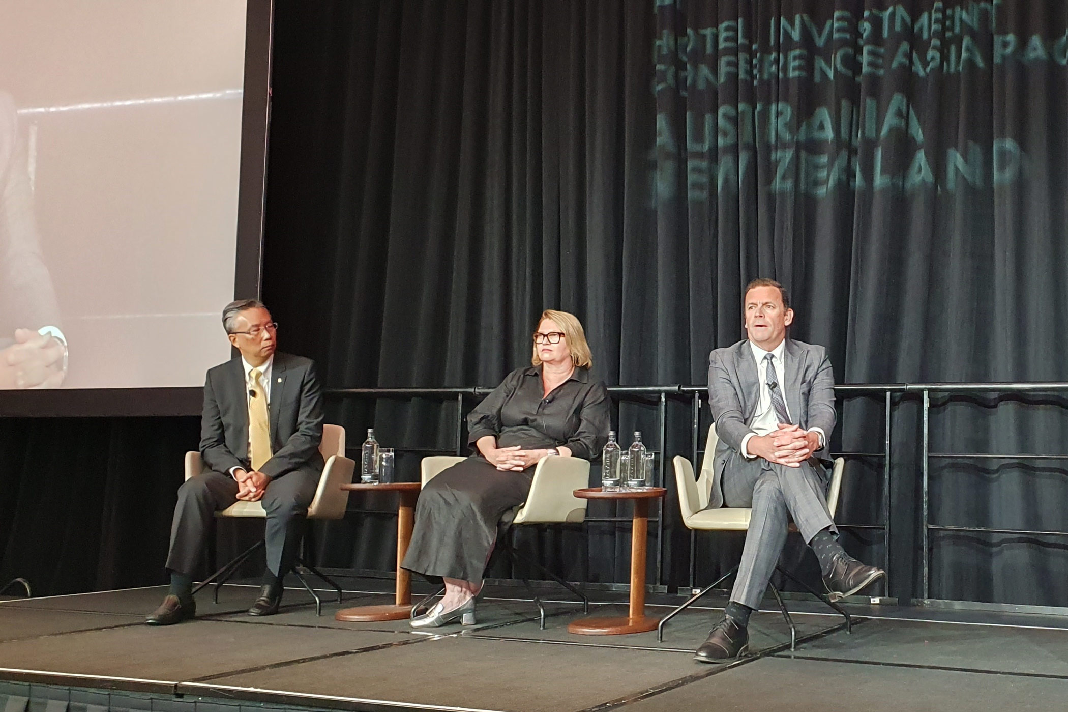 From left: Choe Peng Sum, of Pan Pacific Hotels Group; Sarah Derry, of Accor; and David Mansfield, of The Ascott, speak on a panel at Hotel Investment Conference Asia-Pacific. (Tamara Thiessen)