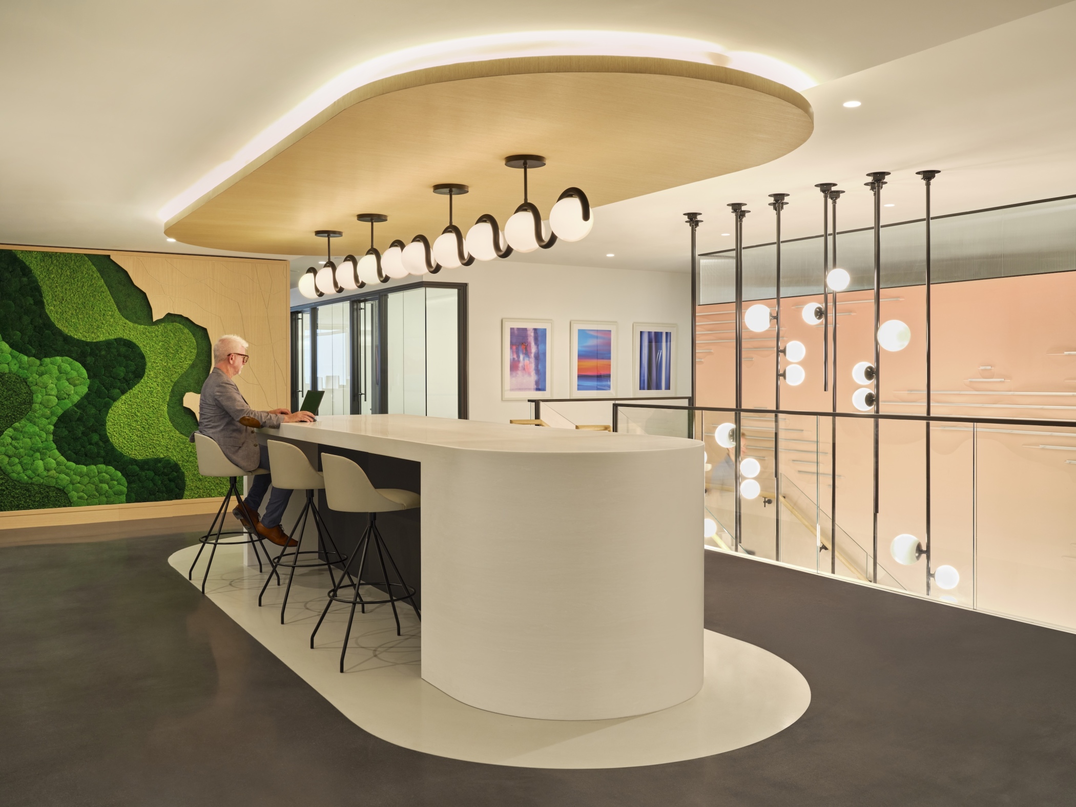 The new level includes a multipurpose room with a retractable partition, conference space, meeting rooms, a coffee bar, a pantry and a lounge anchored by a living green wall. (JTM Construction Group)