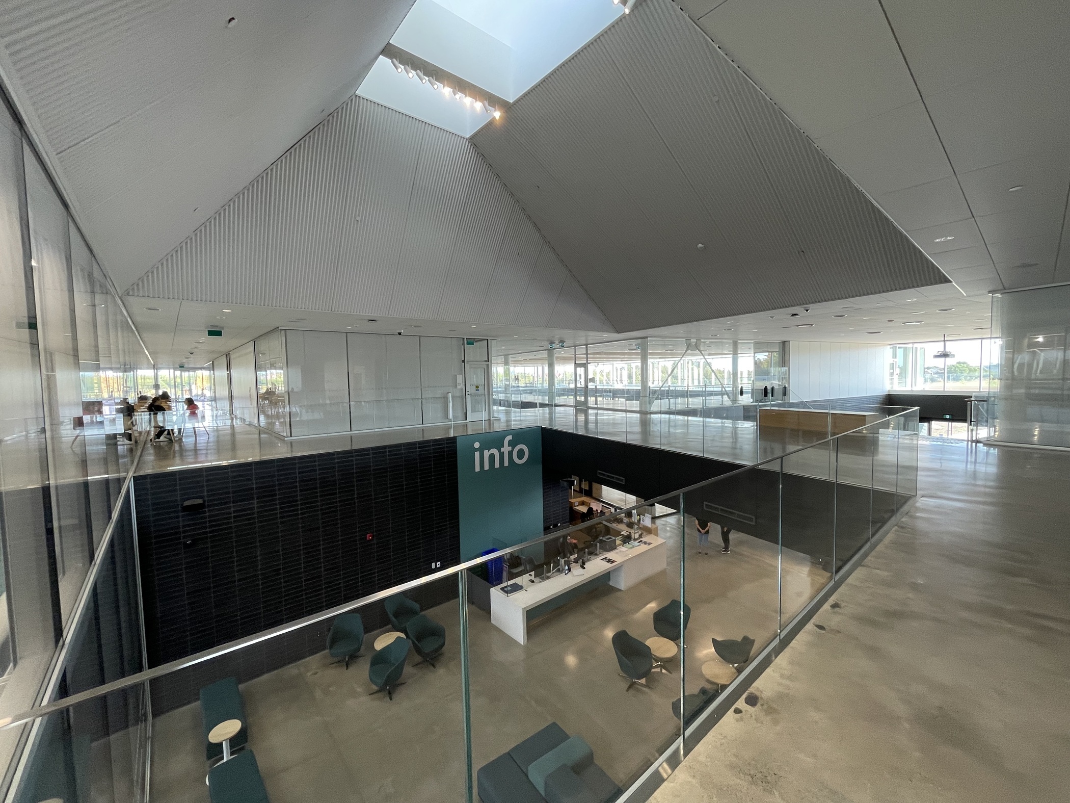 The main information desk is located on the ground floor, but visitors coming through the main entrance on the upper level can see the desk through an opening in the floor. (Andy Peters/CoStar)