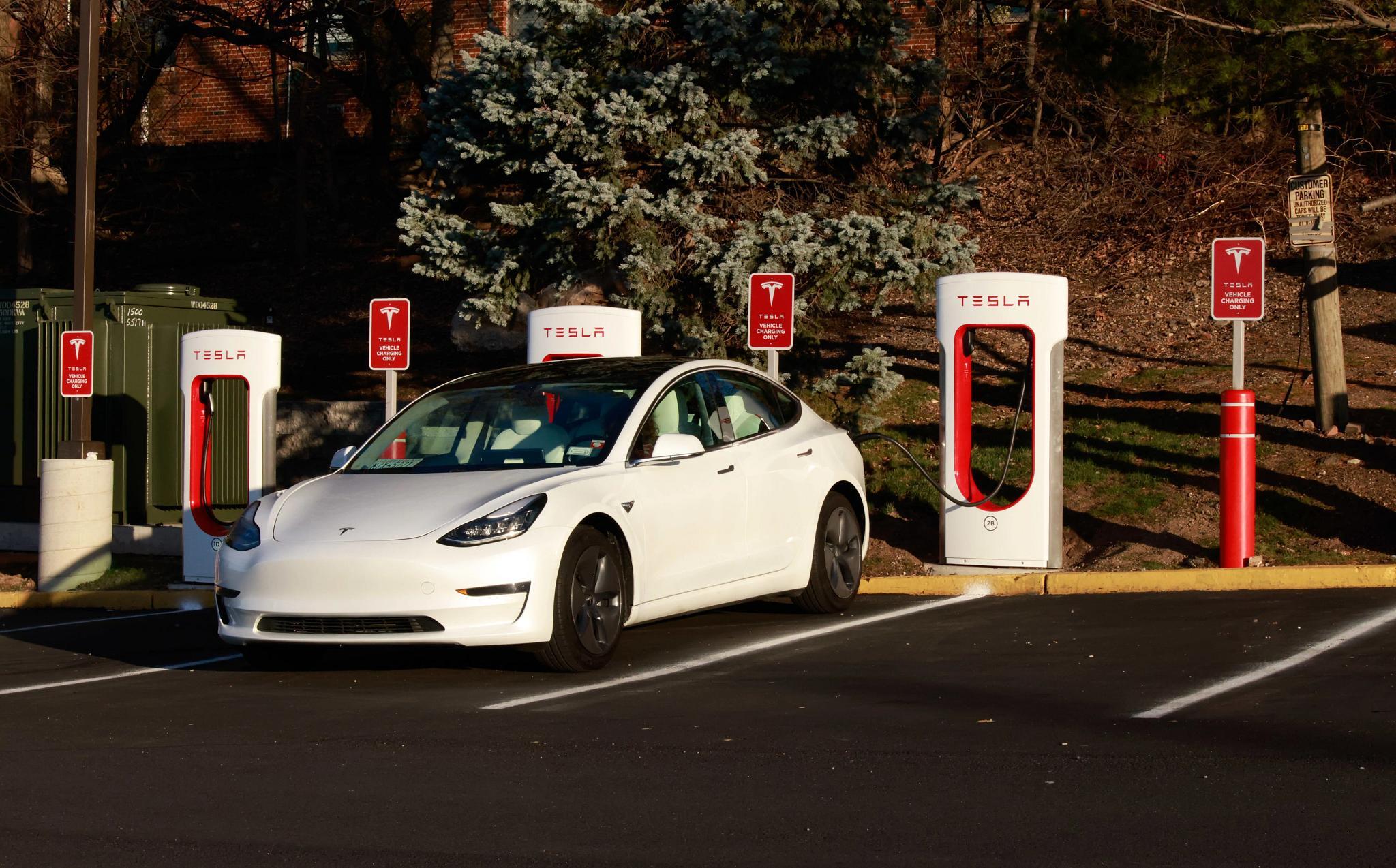 A vehicle sits at a Tesla charging station in Union City, New Jersey. (Photo by Kena Betancur/VIEWpress via Getty Images) (Corbis via Getty Images)