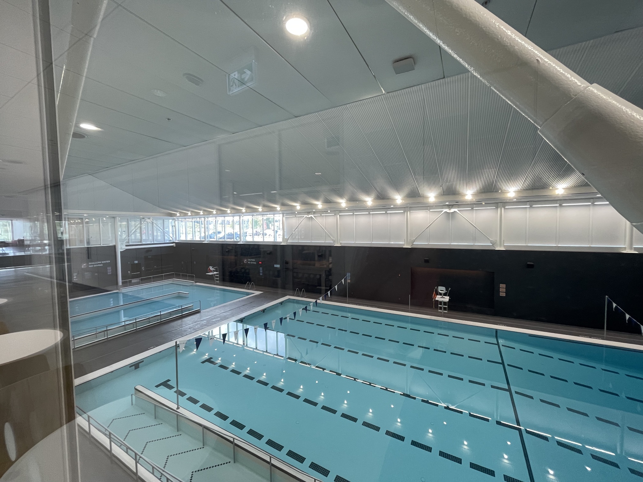 The facility has a pool for swimming laps and a separate pool for teaching swim lessons. A ribbon of windows provides daylight in the natatorium. (Andy Peters/CoStar)