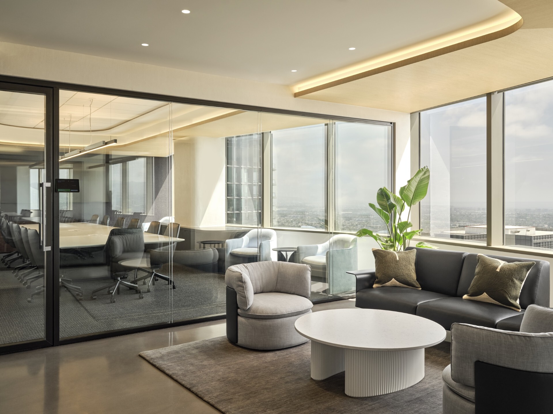 The new amenities floor at Bain & Co.’s Century City office aims to emulate a private club, from curated artwork and soft lighting to modern furniture arrangements. (JTM Construction Group)