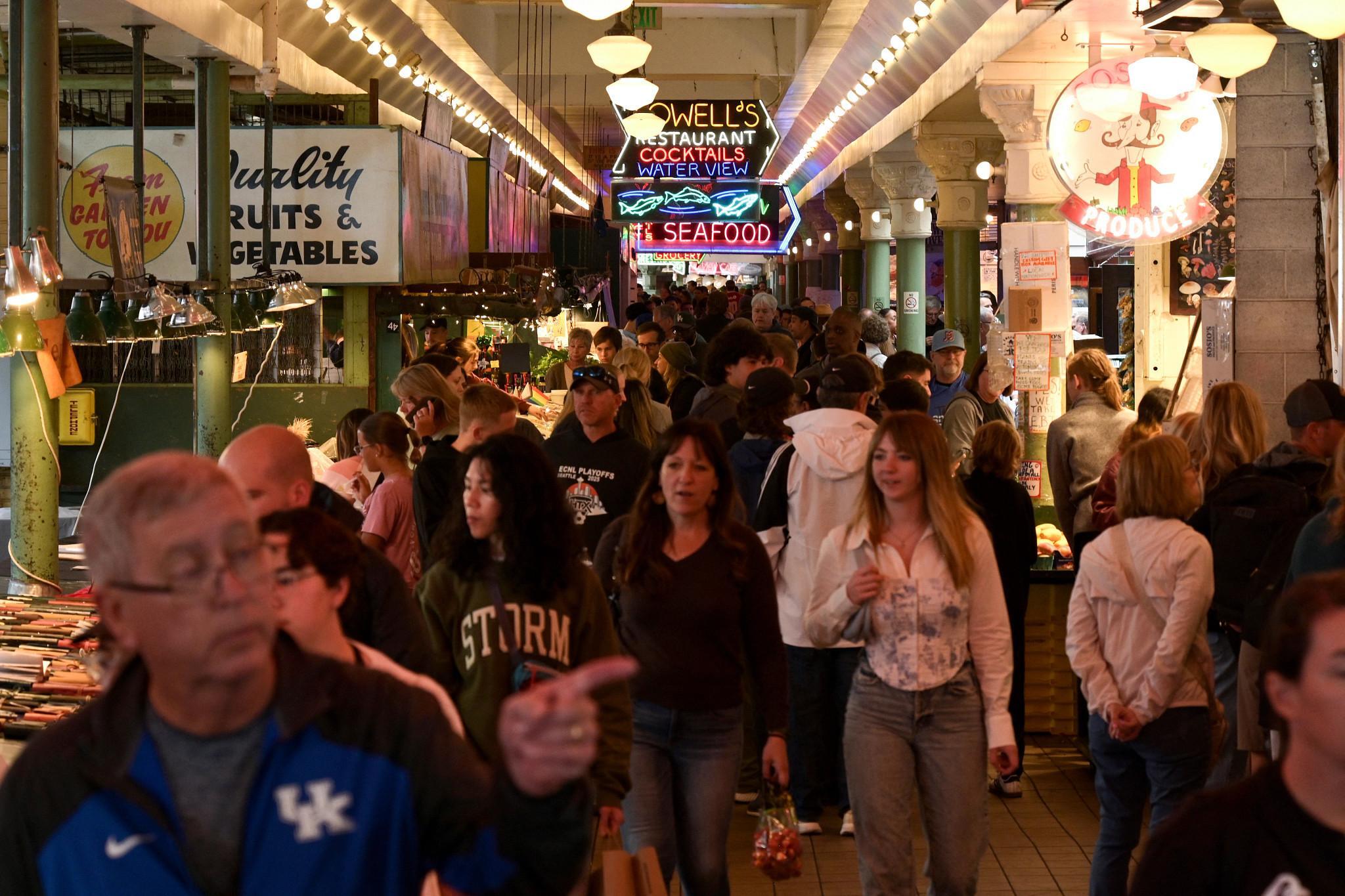 People visit the Pike Place Market in downtown Seattle, Washington on June 25, 2025. (Photo by JUAN MABROMATA / AFP) (Photo by JUAN MABROMATA/AFP via Getty Images) (AFP via Getty Images)