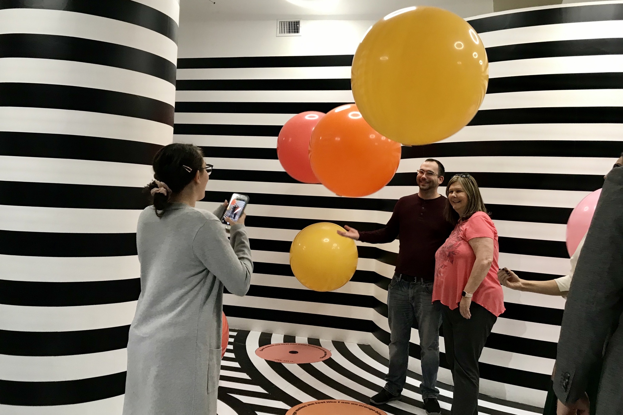Michelle Barnhardt, right, poses for a photo with her son Matthew, left, who was visiting during the holidays at Color Factory in Houston. Like many experiential pop-ups, Color Factory is packed with plenty of social media-worthy backdrops that encourage uses to share their experiences. (Marissa Luck/CoStar News)