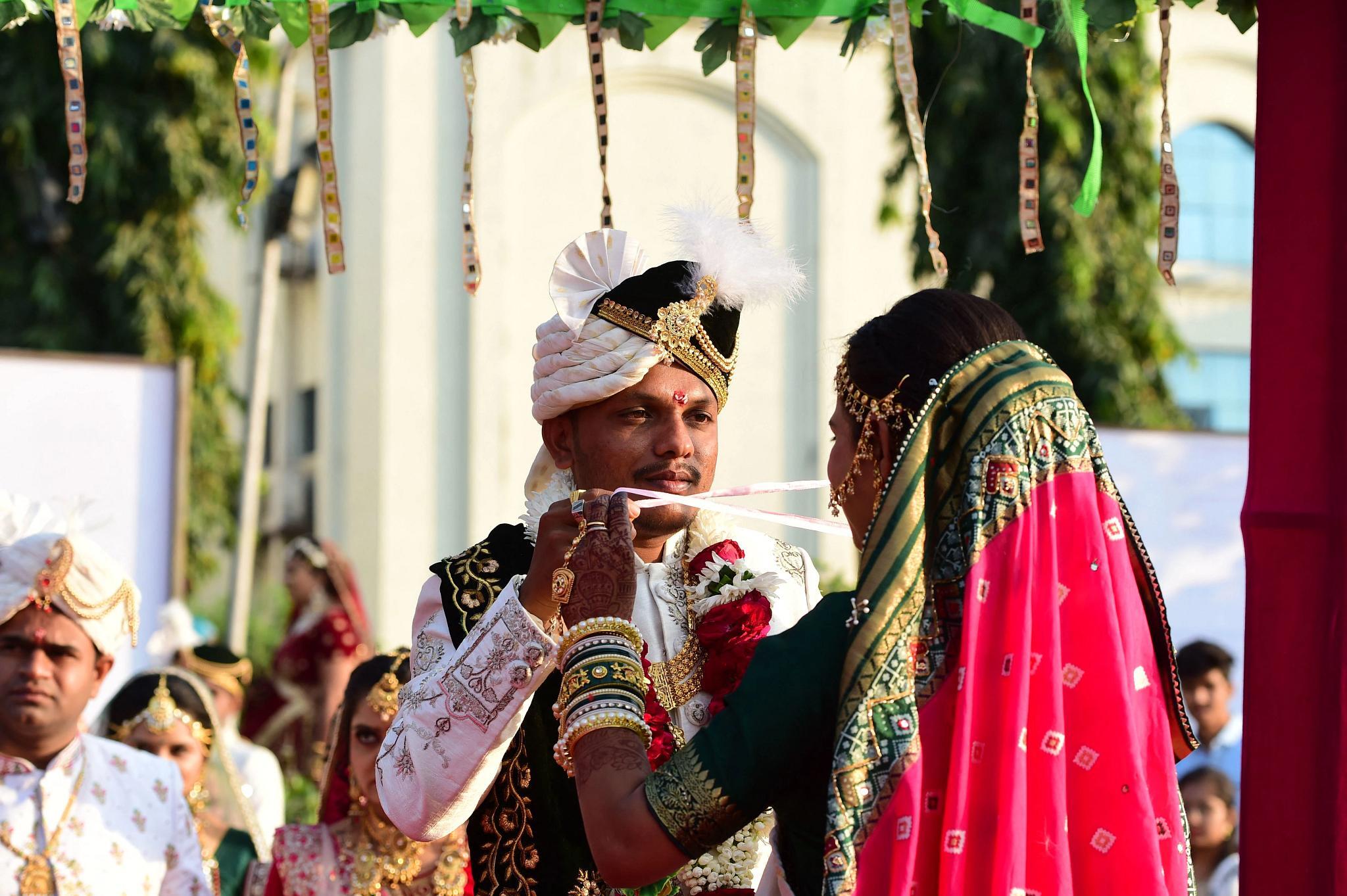 Couples from all religions arrive to take part in a mass marriage ceremony on the outskirts of Surat, on Dec. 24, 2022. Some 300 couples were to be wedded in this mass marriage ceremony. (Getty Images)