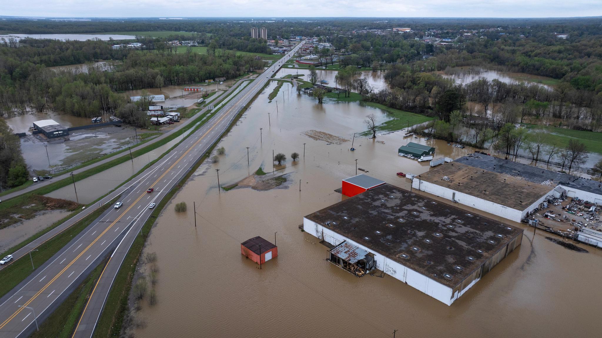 Thunderstorms, heavy rains, high winds, and tornadoes have plagued the U.S. South and Midwest for several days, causing widespread damage. In an aerial view, floodwaters surround buildings and cover roadways on April 6, 2025, in Poplar Bluff, Missouri. (Getty Images)
