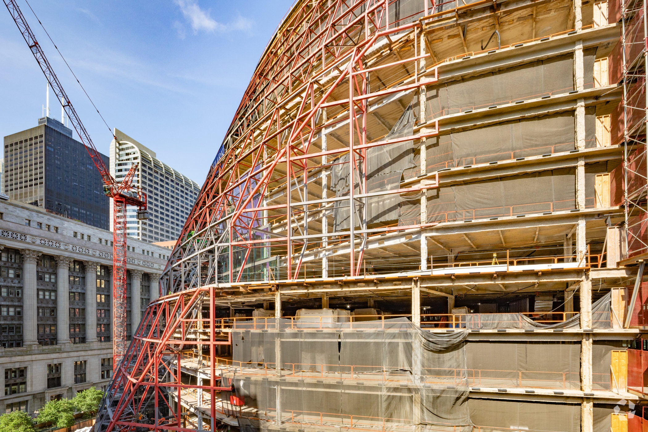 Tourists and commuters have gotten an up-close look as construction workers overhaul the James R. Thompson Center in the center of Chicago's Loop business district. Google plans to move into the building sometime in 2027. (Robert Gigliotti/CoStar)