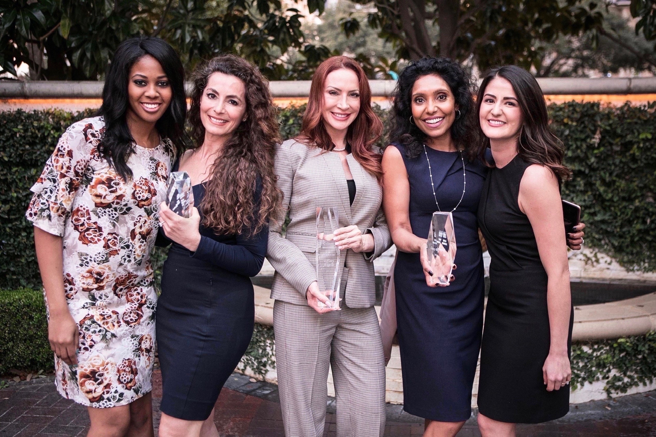Women at various commercial real estate firms helped Xochitl Reyes, far right, along her trek to become a broker. They include, from left, Vada Hayes, a client services specialist at Colliers; Jihane Boury, a senior vice president at  CBRE; Tiffany Angelle, an executive vice president at JLL; and Lizzie Blake, a senior vice president at Colliers. (Xochitl Reyes)