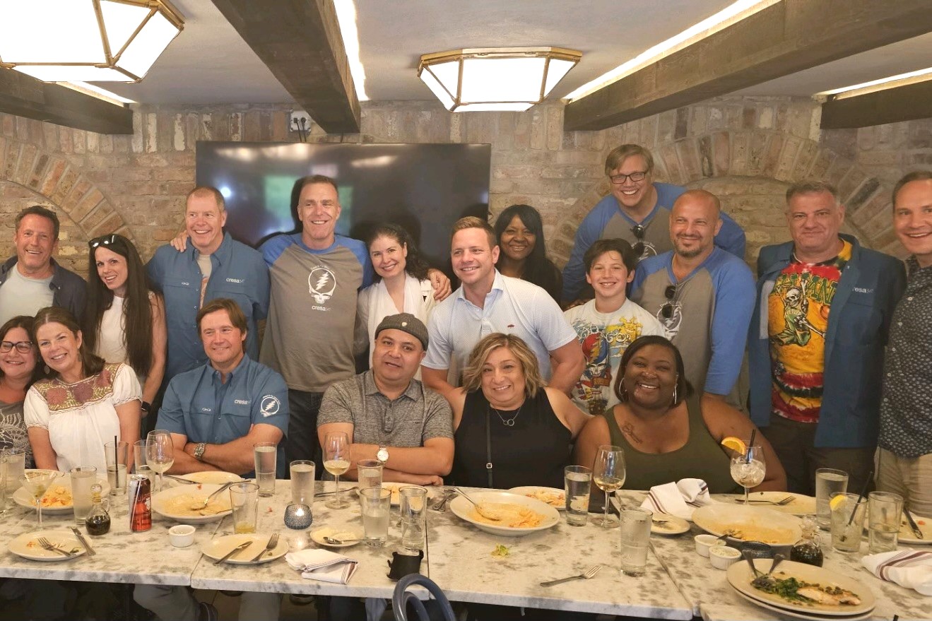 A group of Cresa employees and their family and friends at a dinner before heading out to see Dead & Co. in Chicago. (Cresa)